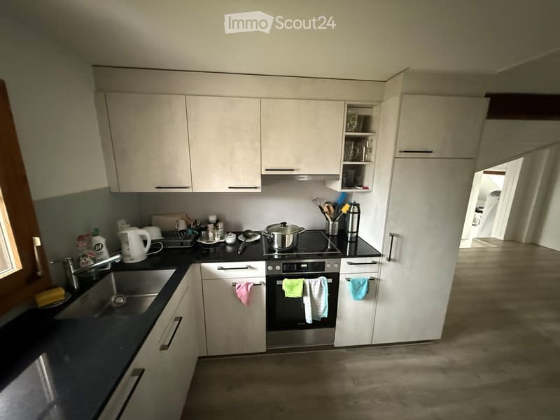 white cabinets, black countertops, stainless steel sink, electric stove, refrigerator