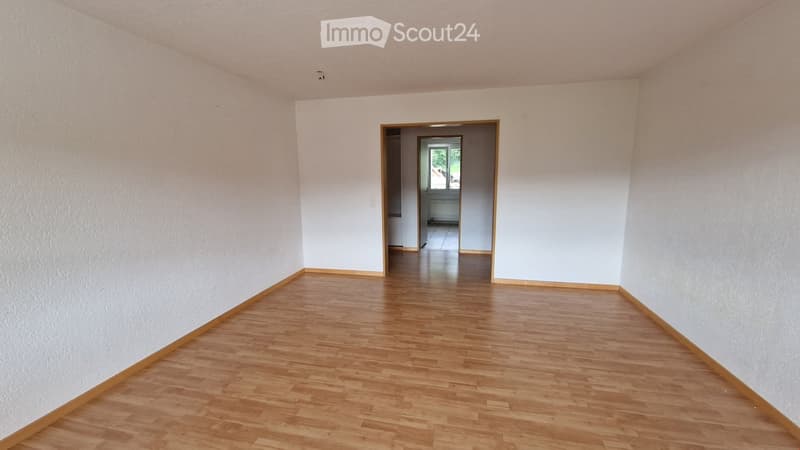 empty room, wooden floor, white walls, door leading to another room