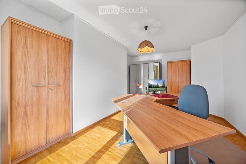wooden desk, blue chair, wooden wardrobe, monitor, lamp, wooden floor