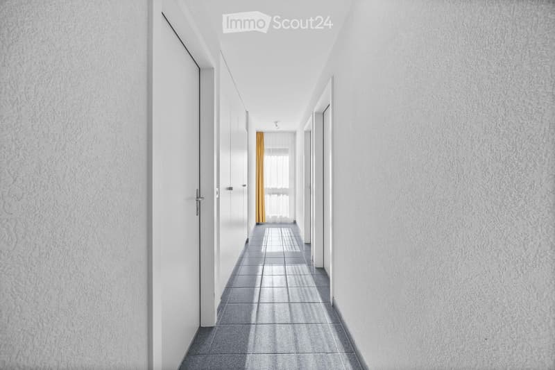 White walls, gray tiled floor, white doors, yellow curtain