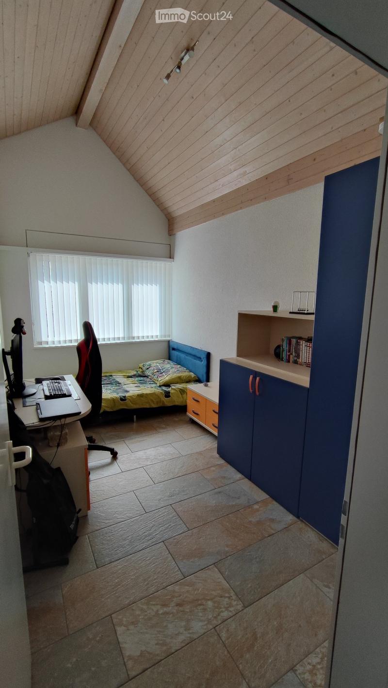 bedroom with desk, bed, wardrobe, desk chair, cabinet with books and computer