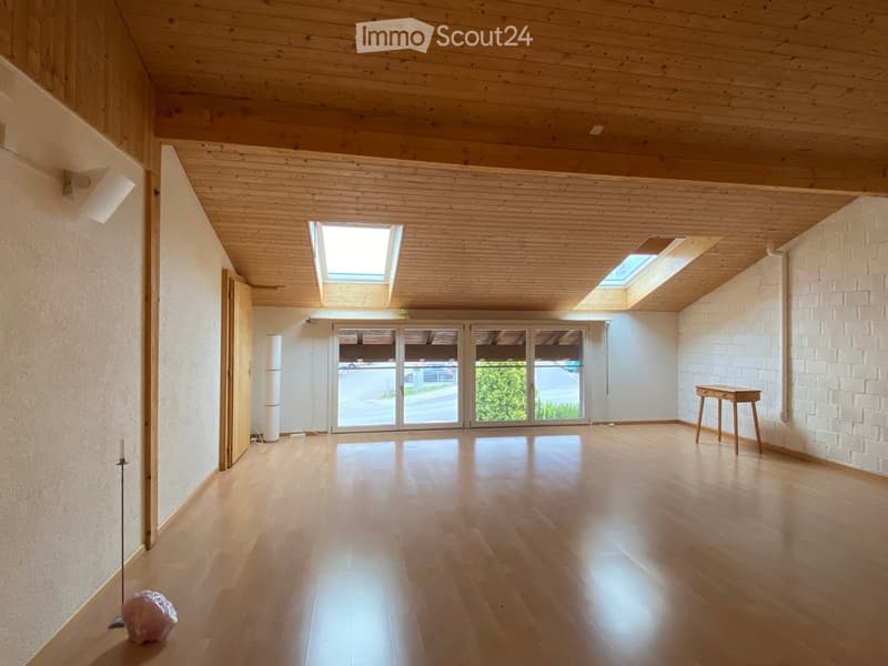 empty room, wooden floor, white walls, wooden ceiling, skylights, sliding glass doors, small table, lamp