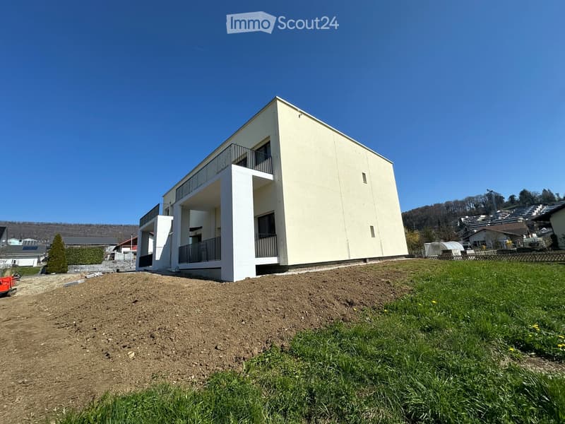 Modern house, white exterior, two floors, balcony on the second floor, raised ground floor