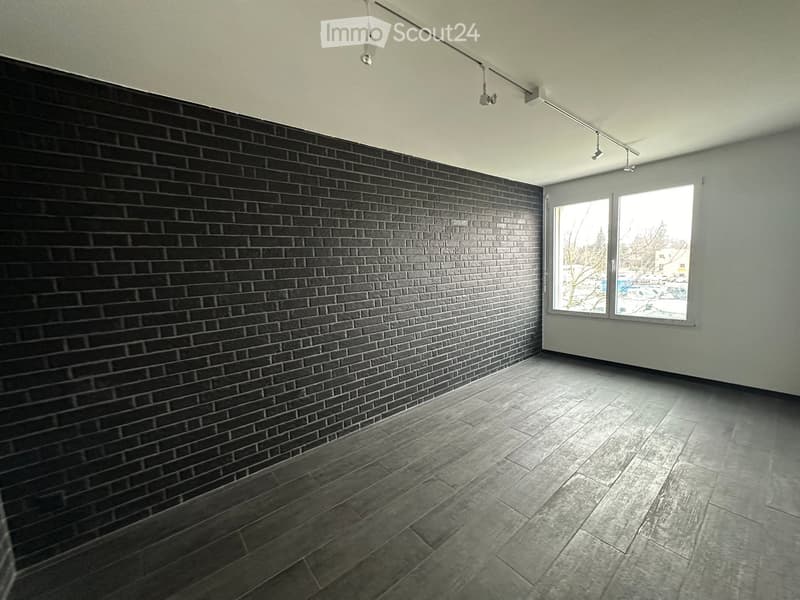 empty room, black brick wall, wooden floor, large window
