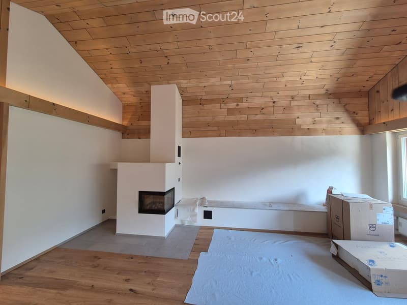 Empty room with wooden flooring, white walls, and a built-in fireplace. No furniture or furnishings are present.