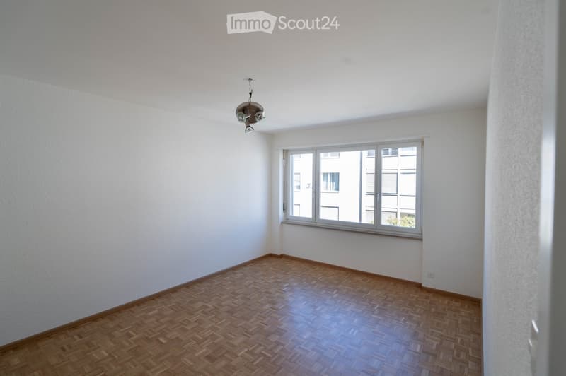 empty room, white walls, wooden floor, large window, ceiling lamp