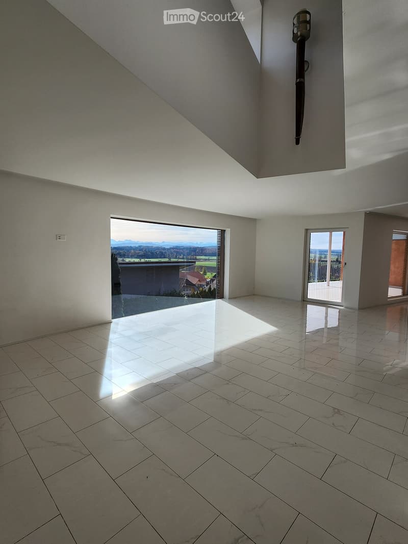 white tile floor, large glass windows, ceiling light, white walls, bright sunlight