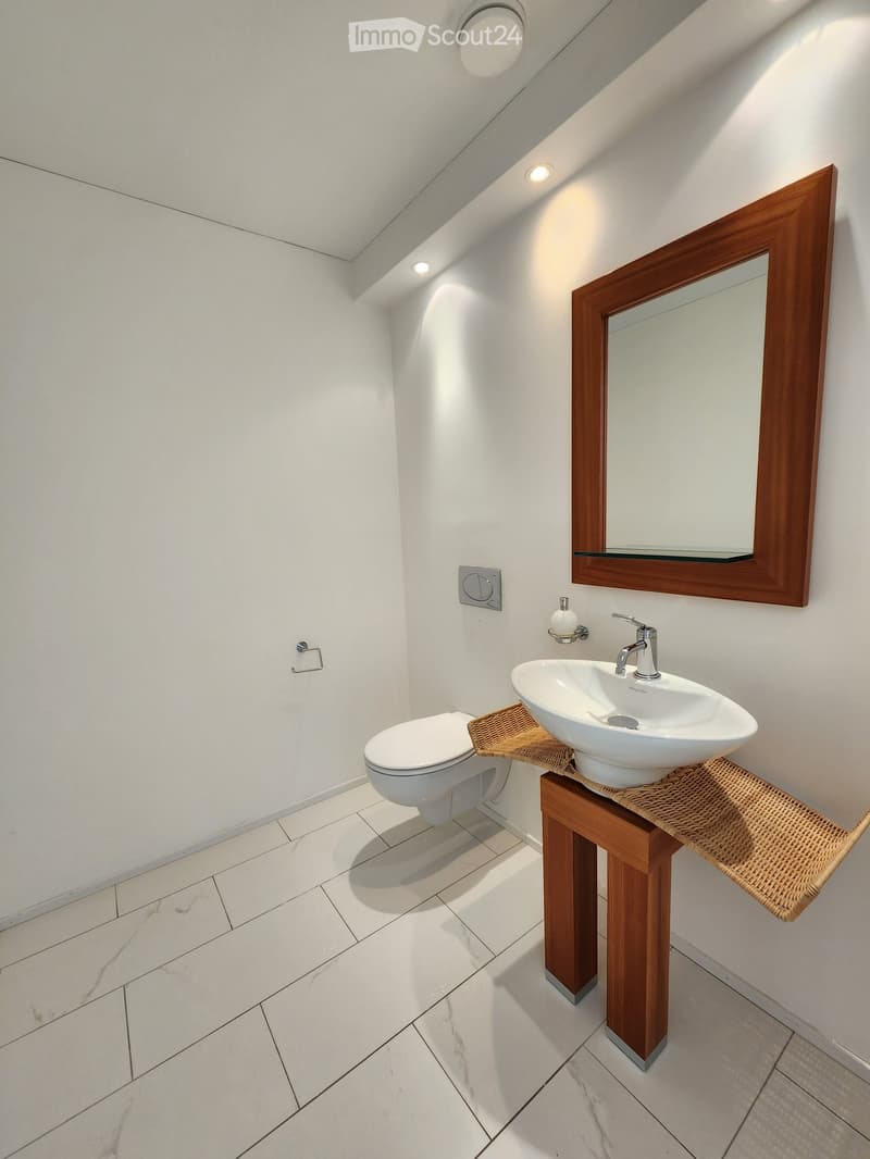 Small bathroom, white tiles, white walls, white toilet, round white sink, mirror