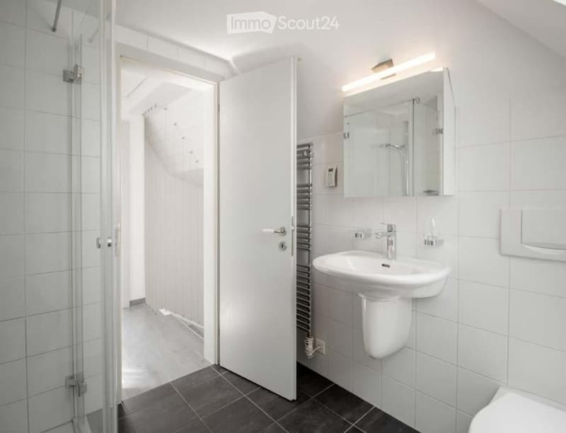 white tiles, white sink, white toilet, white shower, white mirror, white door