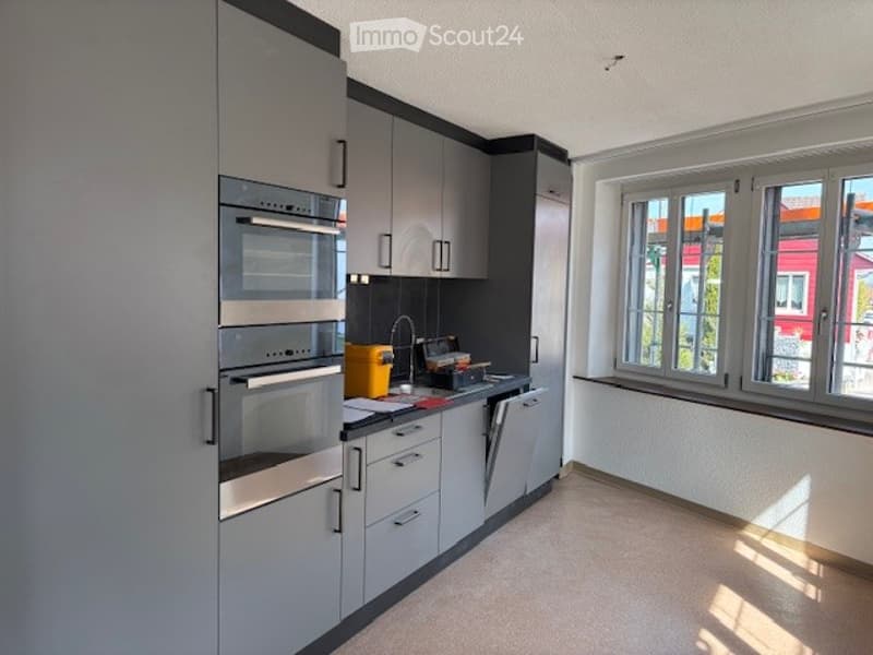 modern kitchen with gray cabinets, stainless steel appliances, and a dishwasher