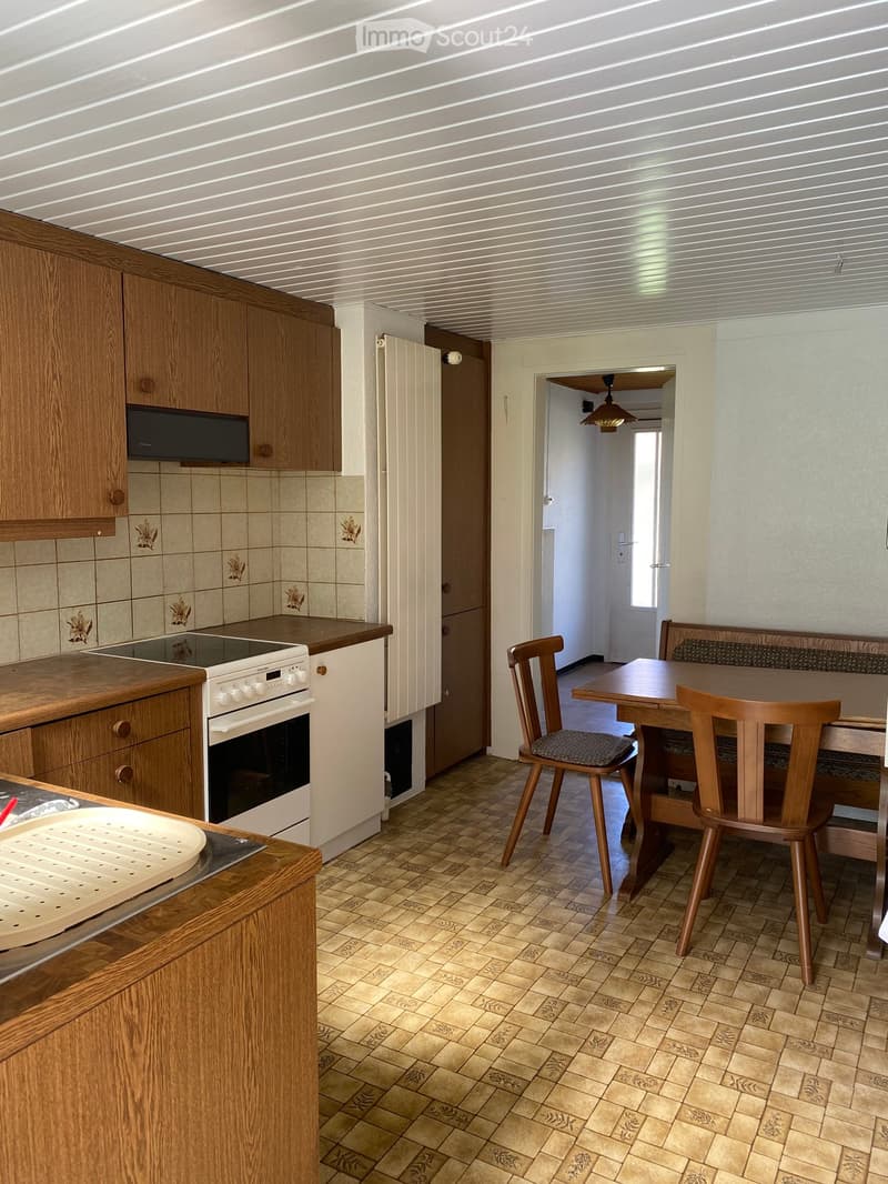 kitchen with wooden cabinets, white appliances, tiled floor, dining area with wooden table and chairs, bench seat, ceiling fan