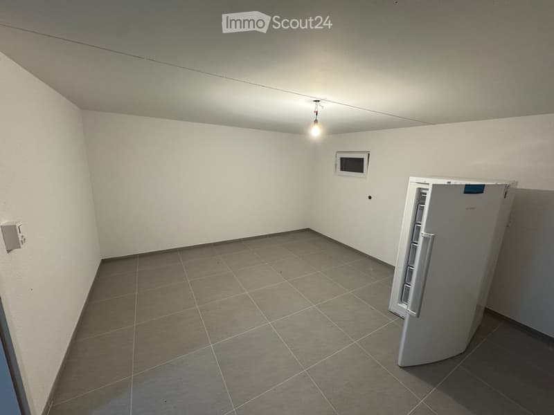 empty room, tiled floor, white walls, single light fixture, small window, open refrigerator