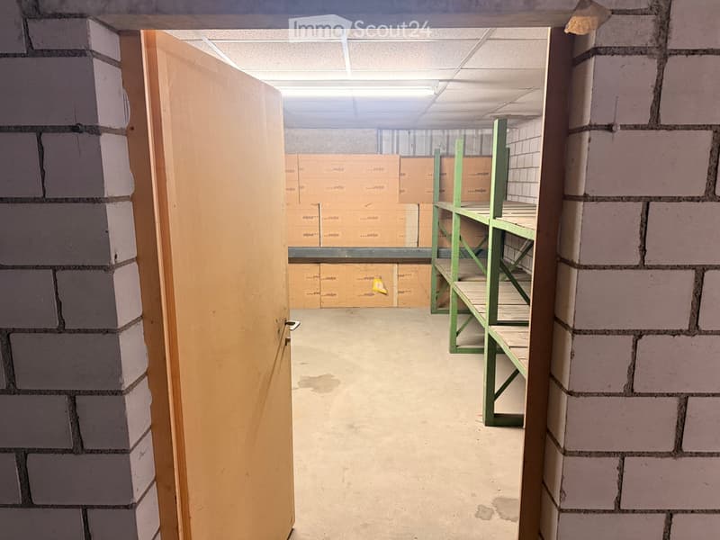 Storage room with a door, shelves, and boxes