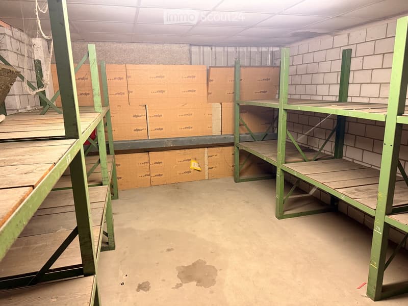 Storage room with wooden shelves, brick walls, and boxes