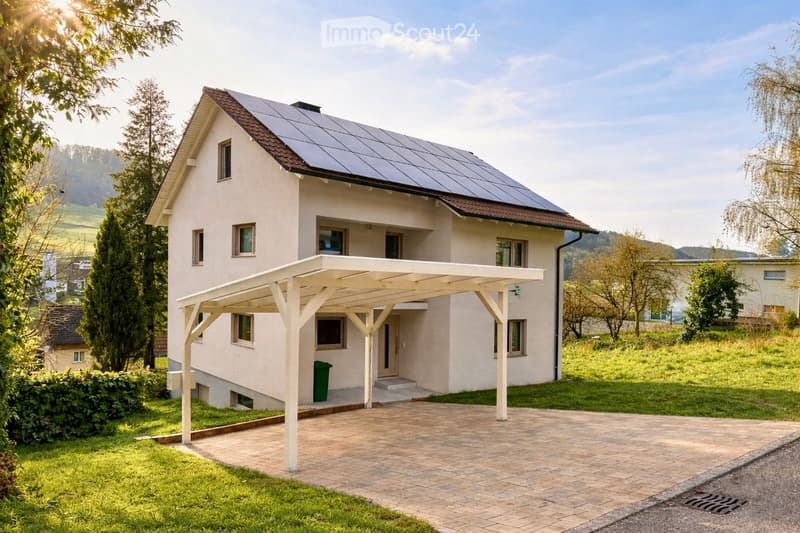 2 story house, white exterior, solar panels on roof, carport, green trash bin