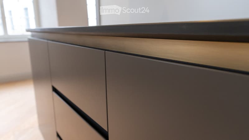 modern kitchen cabinet with drawers and a black countertop