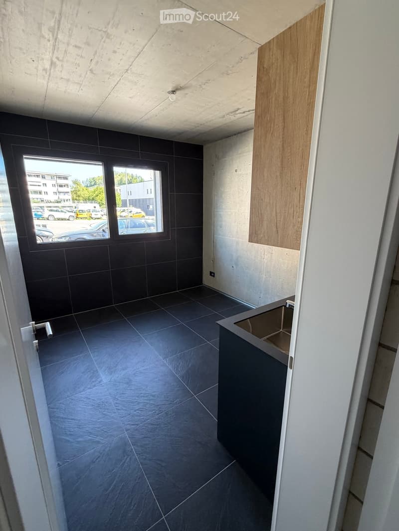 empty room, black tiles, sink, window, wooden cabinet