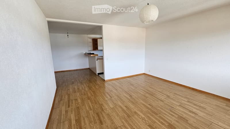 empty room, wooden floor, white walls, kitchen area, power outlet