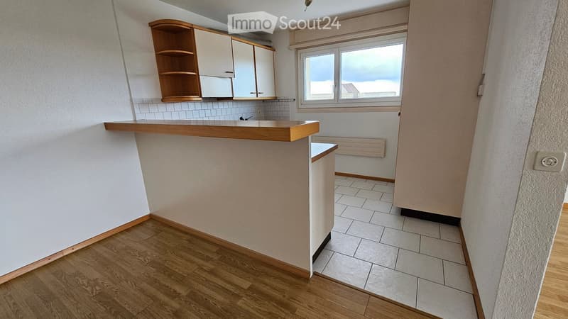 kitchen with wooden counter, white tiles, wooden floor, white cabinets, window