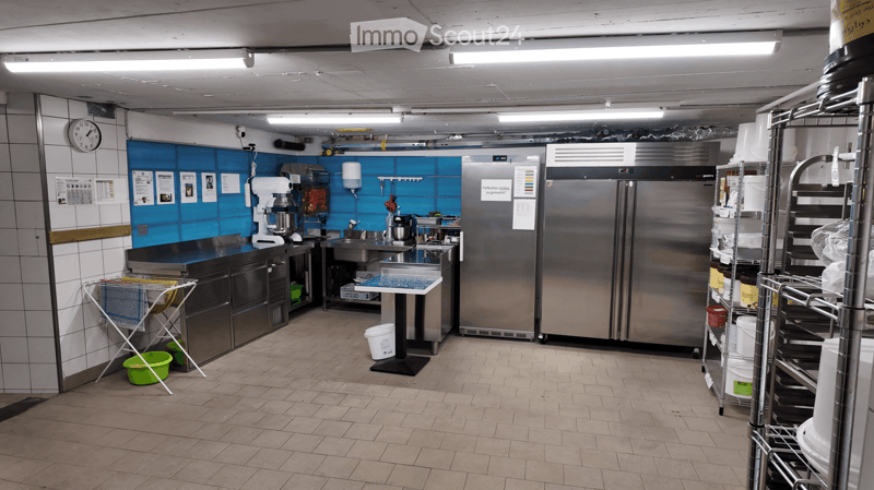 commercial kitchen with tiled floors, stainless steel appliances, large counter, refrigerators, washing machine