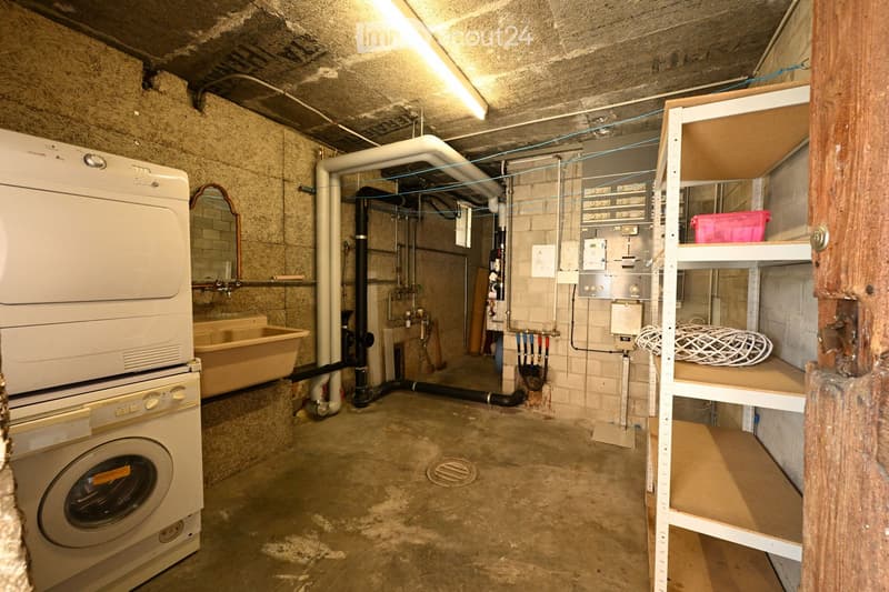 Laundry room with washing machine, dryer, sink, and shelves