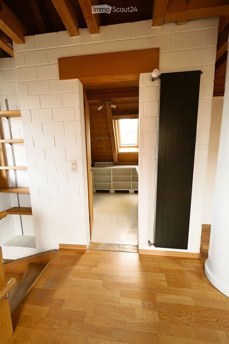 wooden floor, white brick wall, wooden ceiling, wooden shelves, open door, small window, wooden handrail