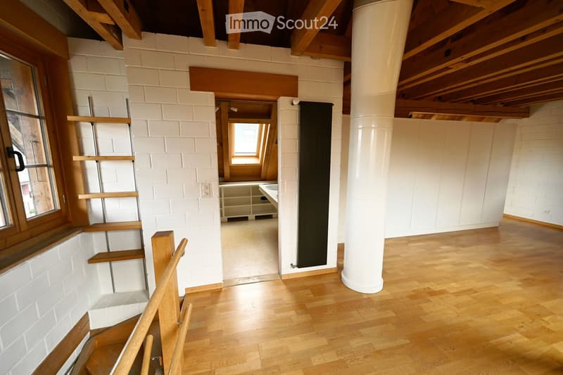 empty room, wooden floor, white brick walls, wooden ceiling, window, wooden ladder, white pillar