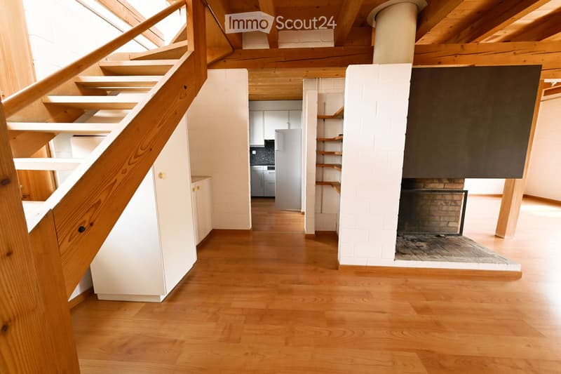 wooden floor, wooden staircase, white walls, fireplace, kitchen area
