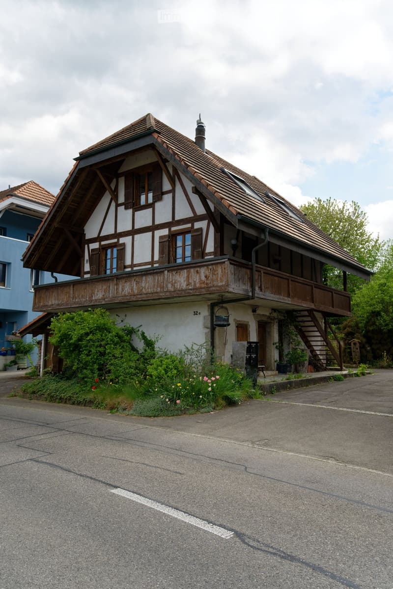 2 story house, brown roof, wooden balcony, white walls, brown trim, garden, street view
