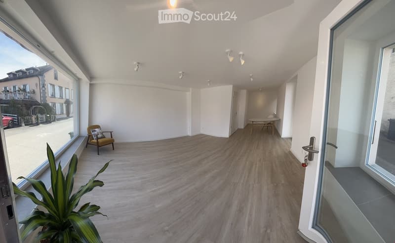 empty room, large windows, wooden floor, white walls, ceiling lights, table and chairs