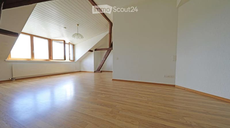 empty room, wooden floor, white walls, wooden beams, windows, radiator