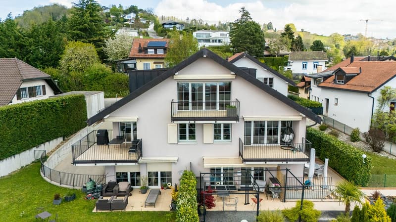 3 story house, white exterior, multiple balconies, solar panels, garden, outdoor seating, view of surrounding area