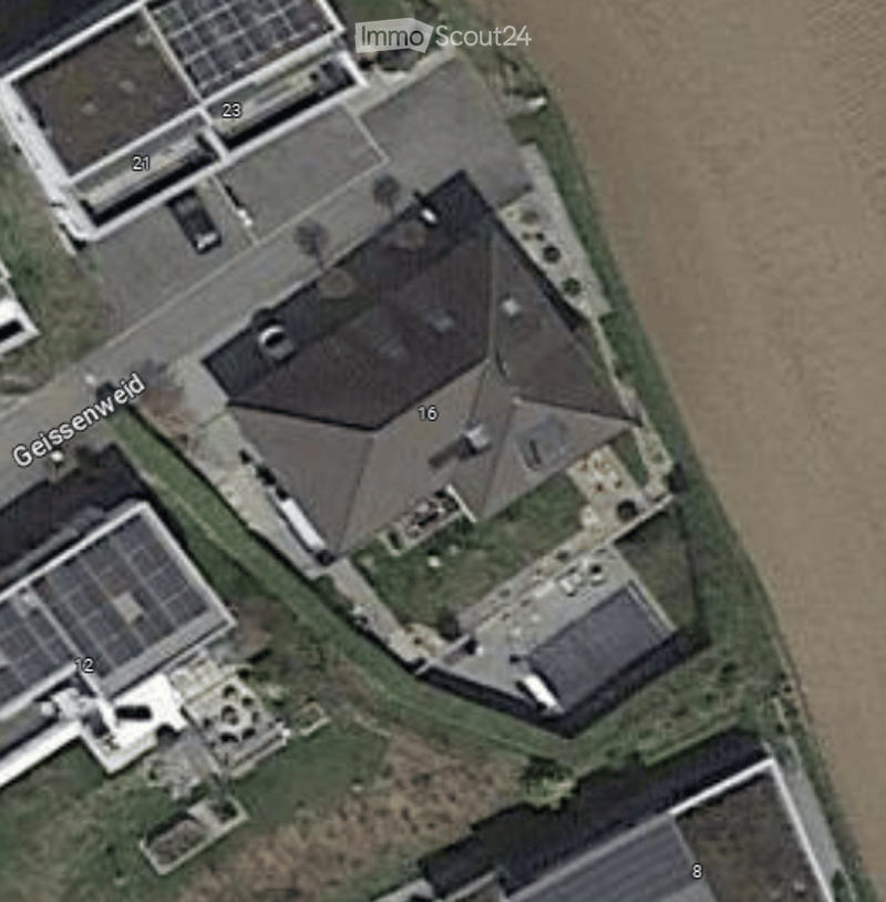 Single-family house, asphalt shingled roof, solar panels, driveway, carport, landscaped yard, green vegetation