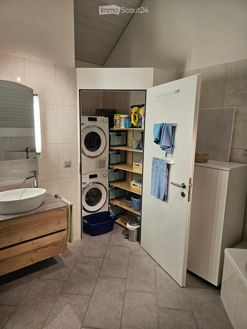 Laundry room with washing machine, dryer, shelves, and a sink