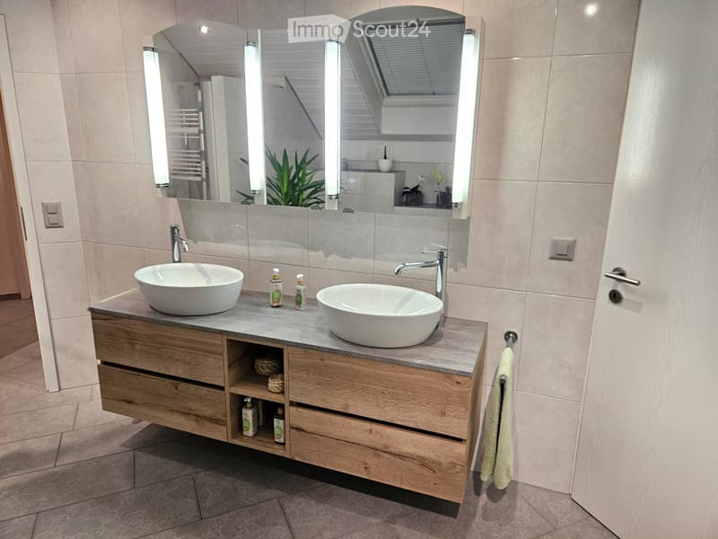 Undermount sinks, built-in vanity, full-length mirror with side lights, tile flooring, white walls, wooden cabinetry, towel bar