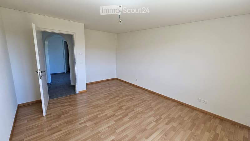 empty room, wooden floor, white walls, open door, power outlets
