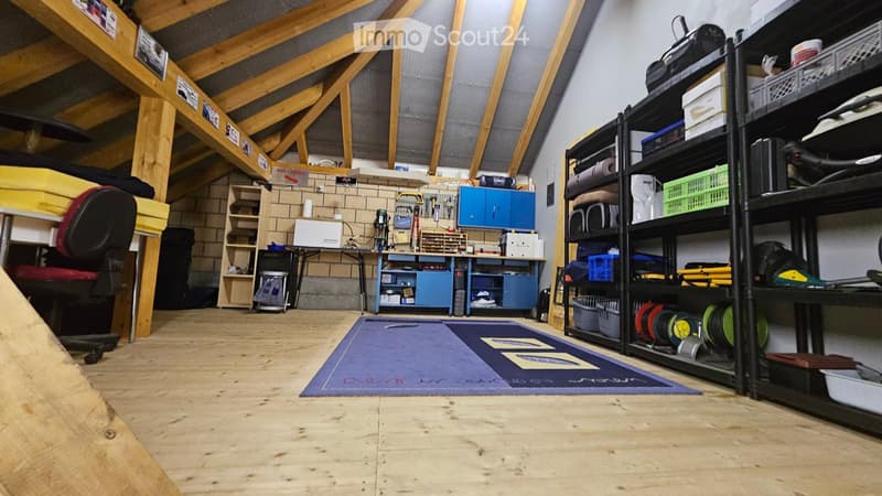 wooden beams, wooden floor, shelves, desk, office chair, carpet, storage boxes, tools