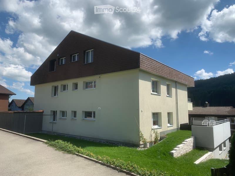 3 story house, beige walls, brown roof, windows, balcony, garden, fence
