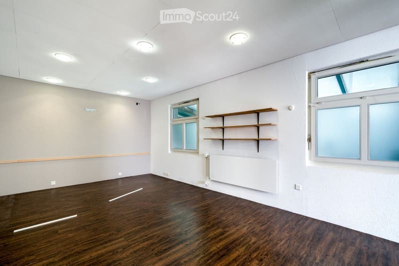 empty room, wooden floor, white walls, three windows, two shelves, ceiling lights