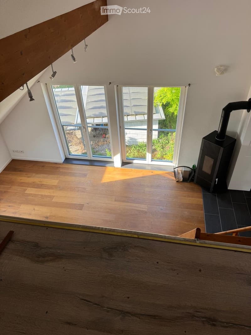 wooden floor, white walls, large glass windows, fireplace