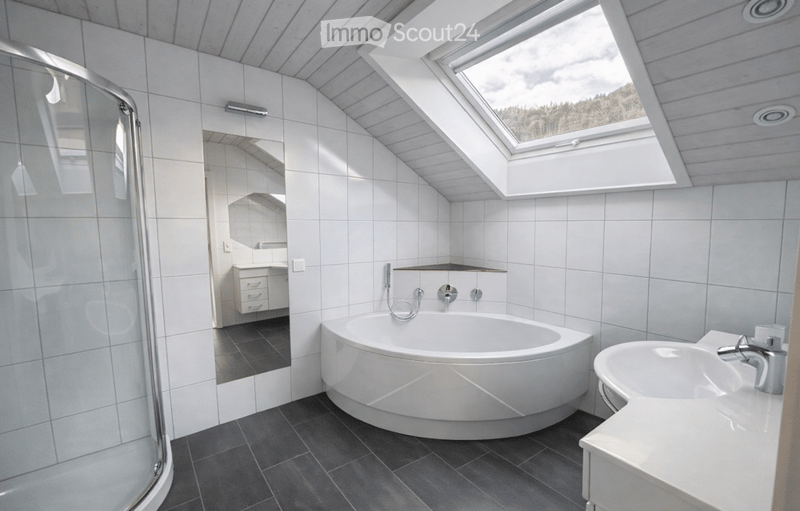 white bathtub, white sink, white tiles, skylight, shower enclosure, mirror
