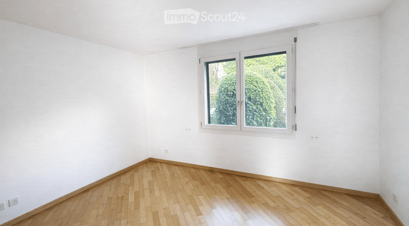 empty room, wooden floor, white walls, window with view to outside