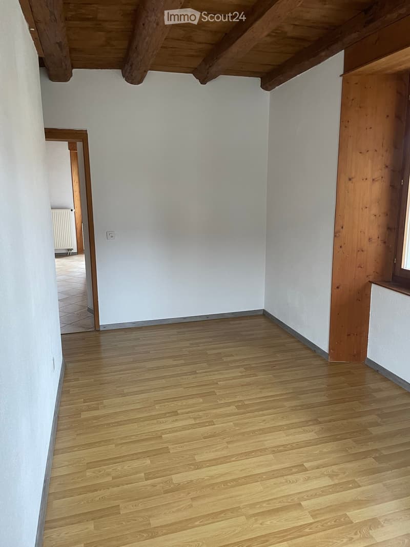 wooden ceiling, parquet floor, white walls, visible power outlet, window with wooden frame