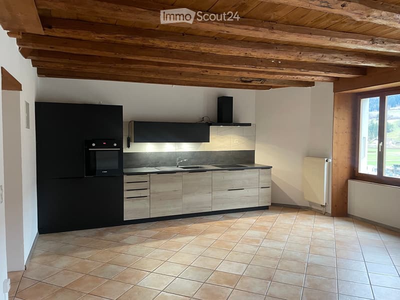 modern kitchen, black cabinets, tiled floor, wooden beams, double sinks, electric oven, microwave, window