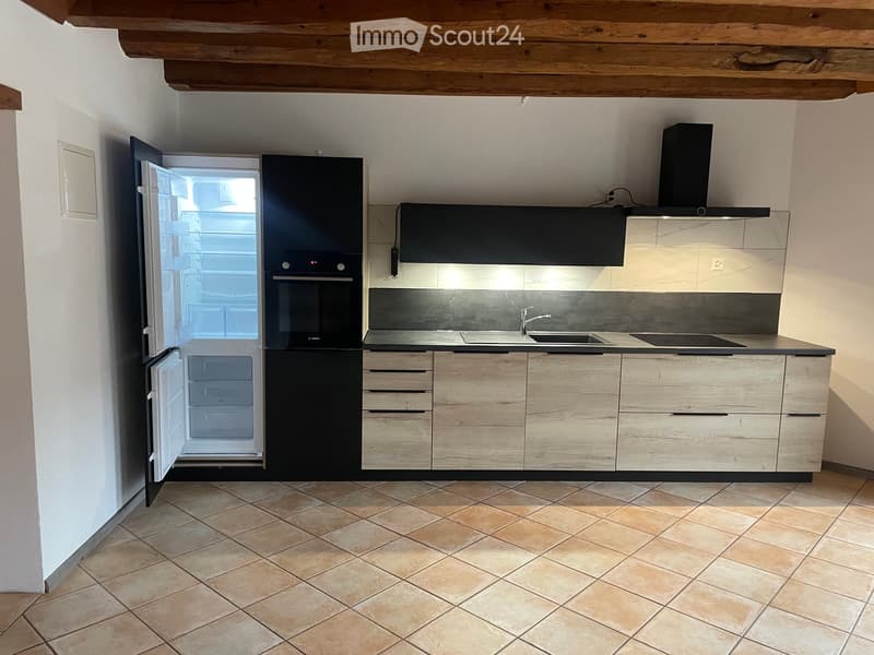 kitchen with wooden ceiling, tiled floor, open fridge, modern cabinets, granite countertop, double sink, oven, exhaust hood