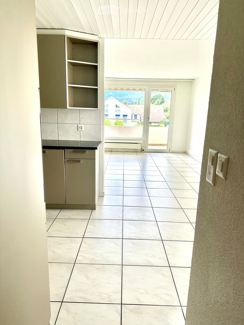 empty room, white tiles, white walls, sliding glass door, balcony, cabinets, power outlets