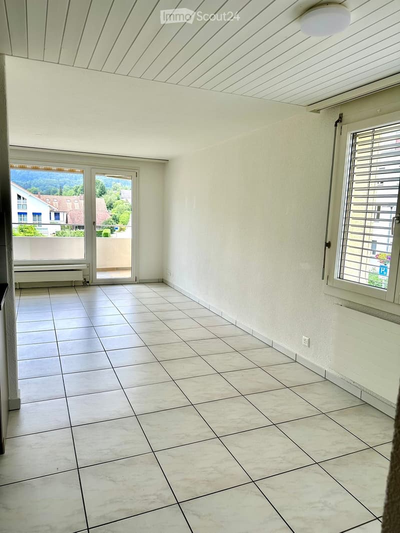 empty room, white tiles, sliding glass door, balcony, windows with blinds, white walls, ceiling light