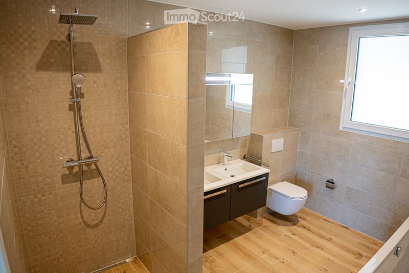 modern bathroom with shower, sink, toilet, wooden floor, beige tiles