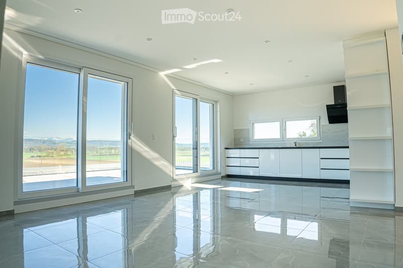 large windows, sliding doors, white kitchen, tiled floor