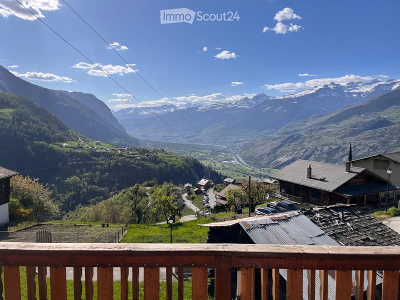 wooden fence, green grass, view of mountains and houses